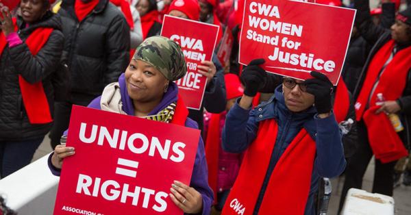 cwa members with posters about justice and rights