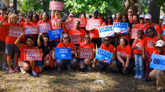 CWA members holding signs supporting Harris and Walz