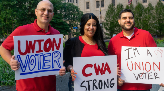 cwa members holding union voter posters
