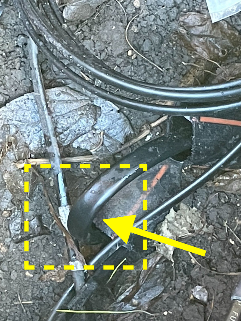 A contractor left a severe bend (yellow arrow) in fiber cable which can cause light loss.