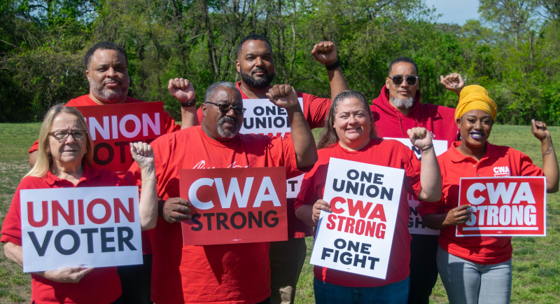cwa members holding signs that say union voter and cwa strong